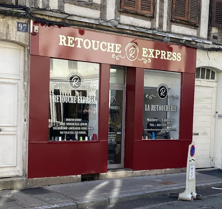 Devanture bordeaux de la boutique Retouche Express au 97 rue de Paris à Auxerre, avec ses deux vitrines